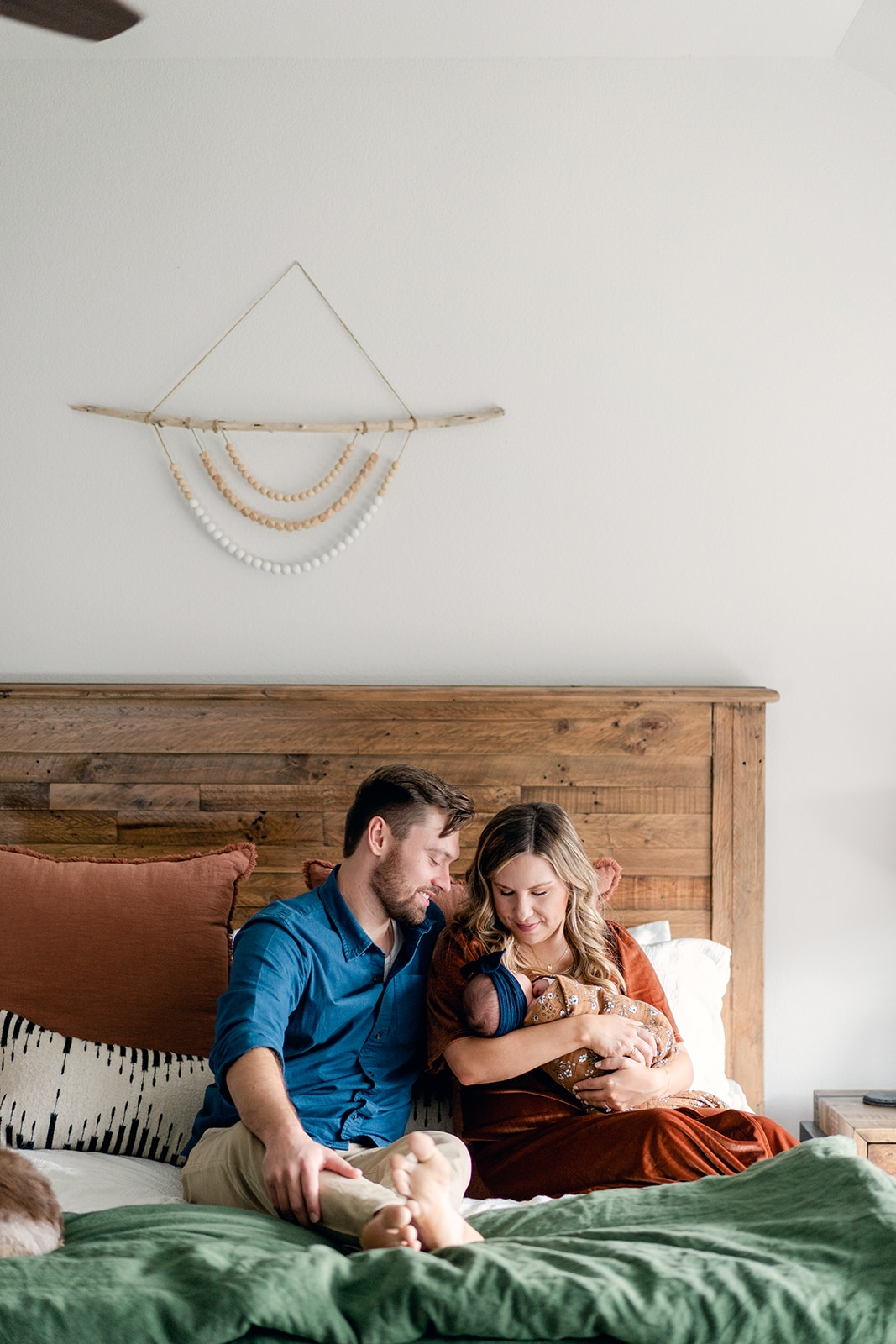 family on bed during boho newborn session