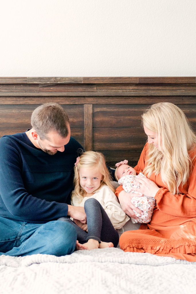 family on bed for in-home newborn session