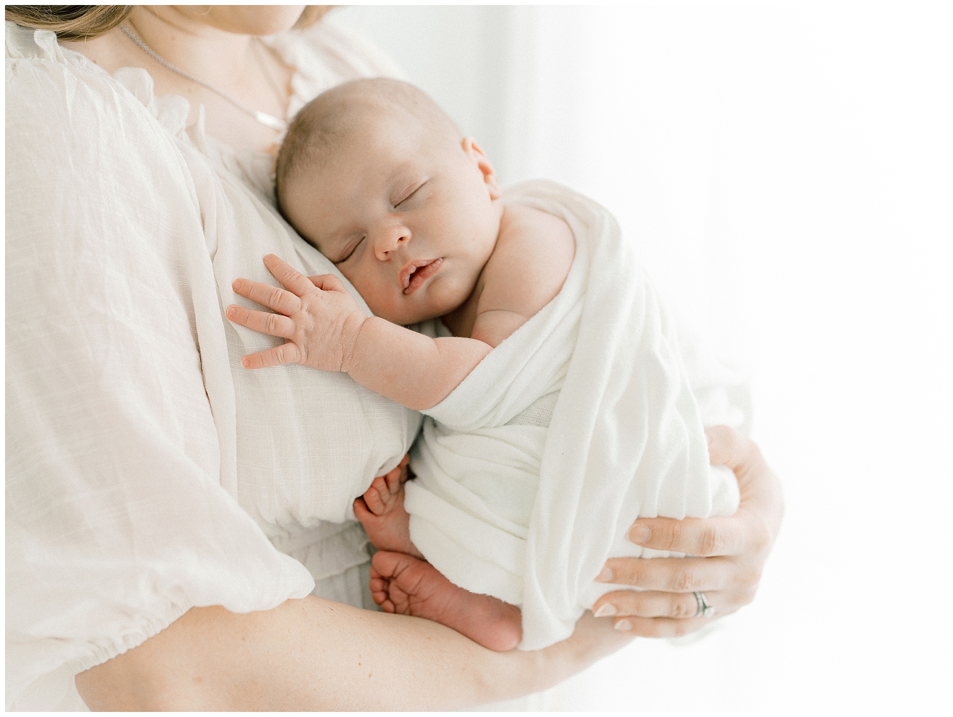 mom holding baby in prosper newborn session